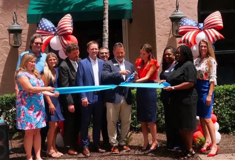 Freedom Ave Maria cutting their grand opening ribbon together.